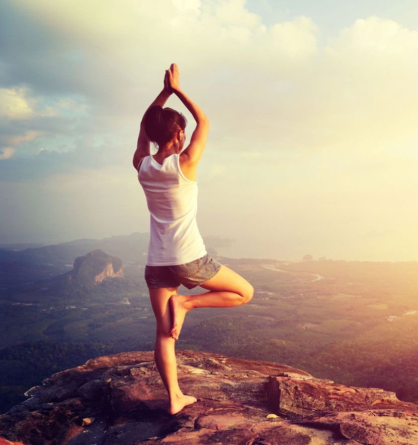 Person doing Yoga on a mountaintop